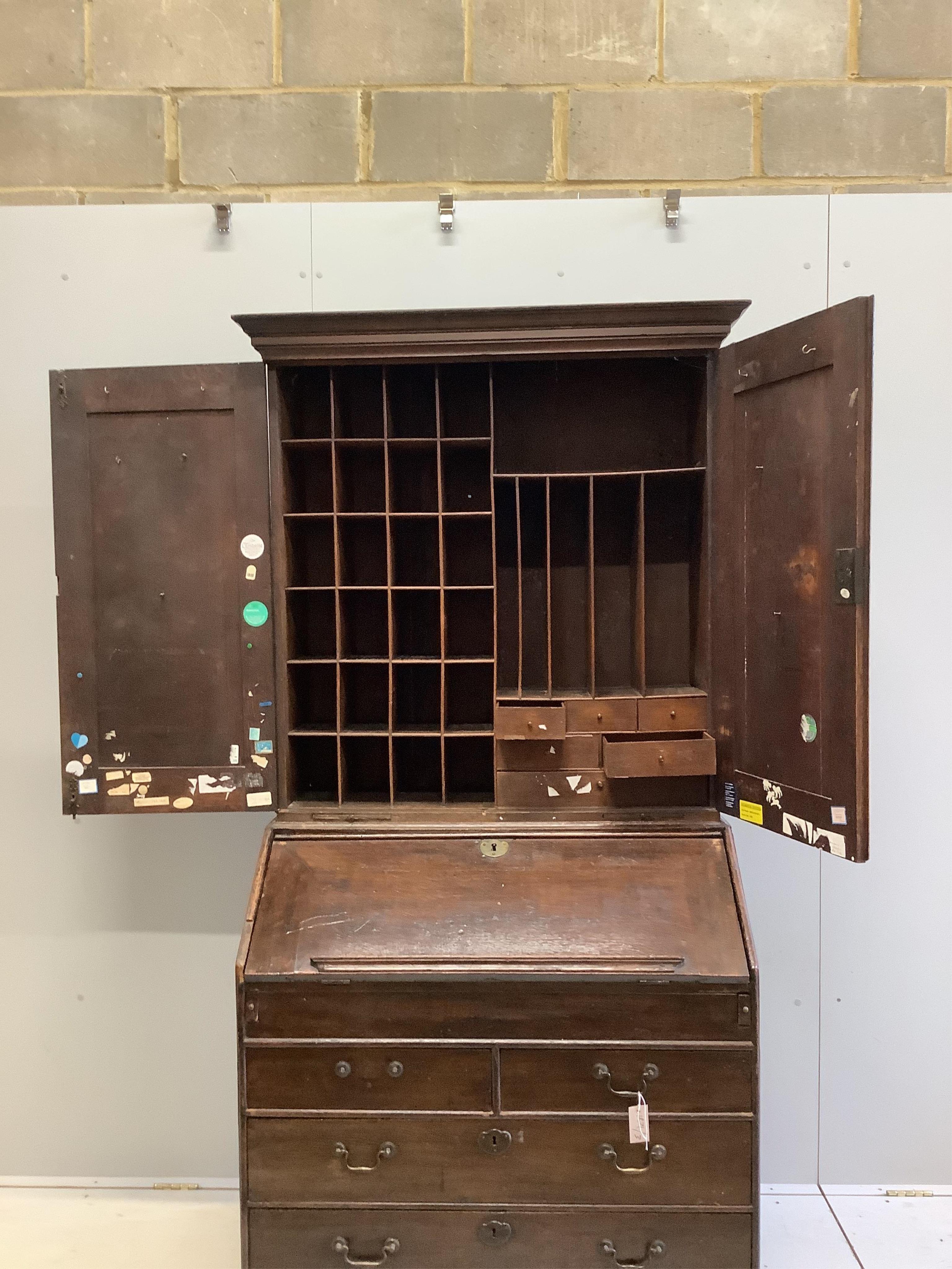 A George III oak bureau cabinet, width 96cm, depth 59cm, height 201cm